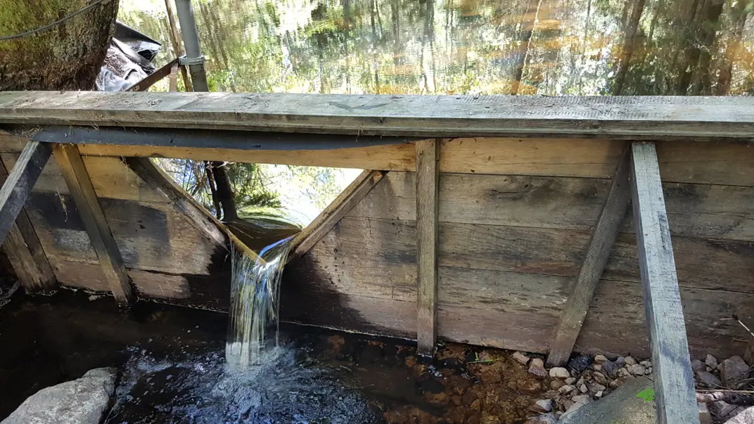 The image shows a weir, constructed for measurement of water flow in a small creek in Asa.