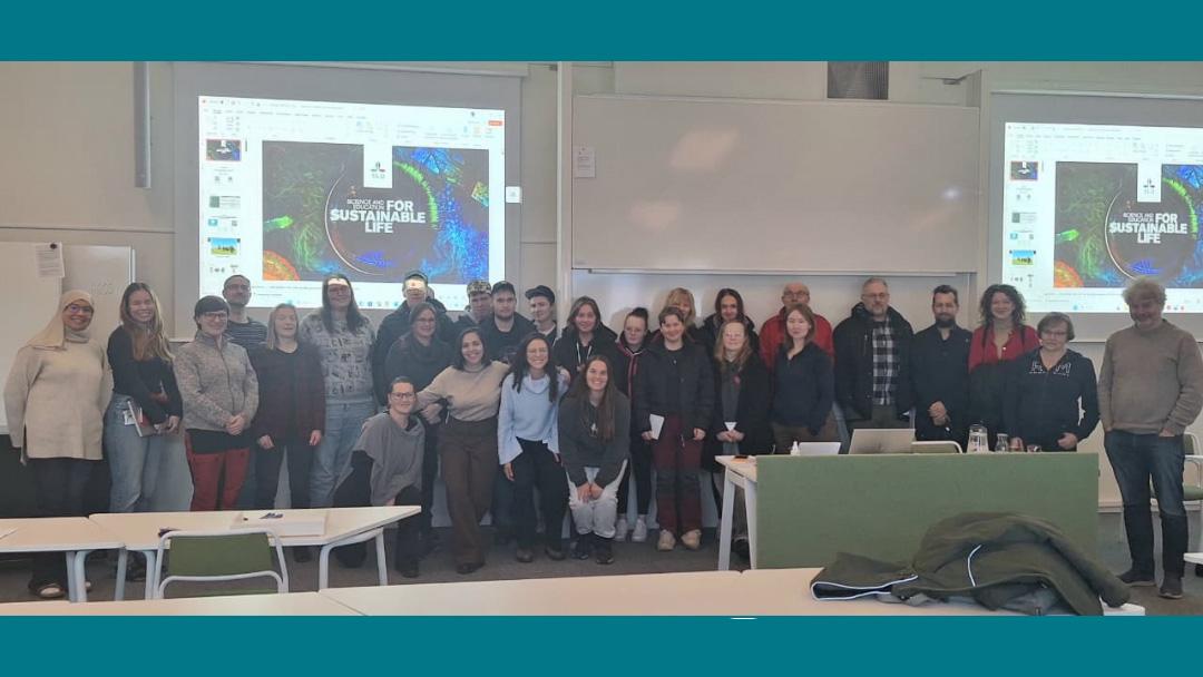 Deltagarna på seminariet samlade framför en projektorduk. Foto.