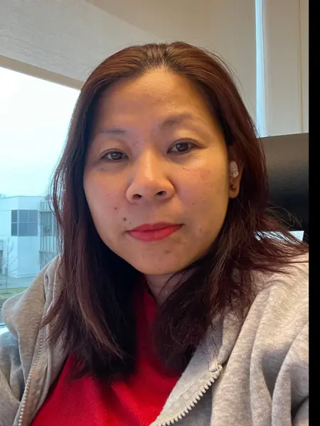 A woman by a window. Photo.