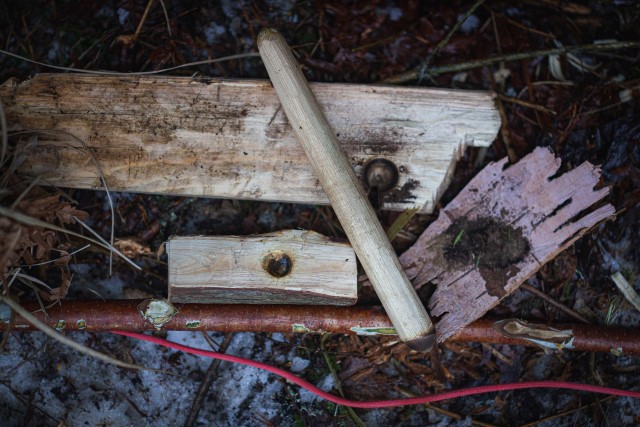 A bow drill on the ground.