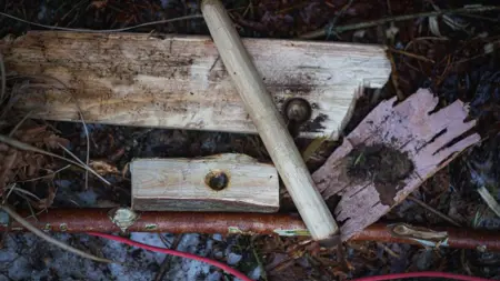 A bow drill on the ground.