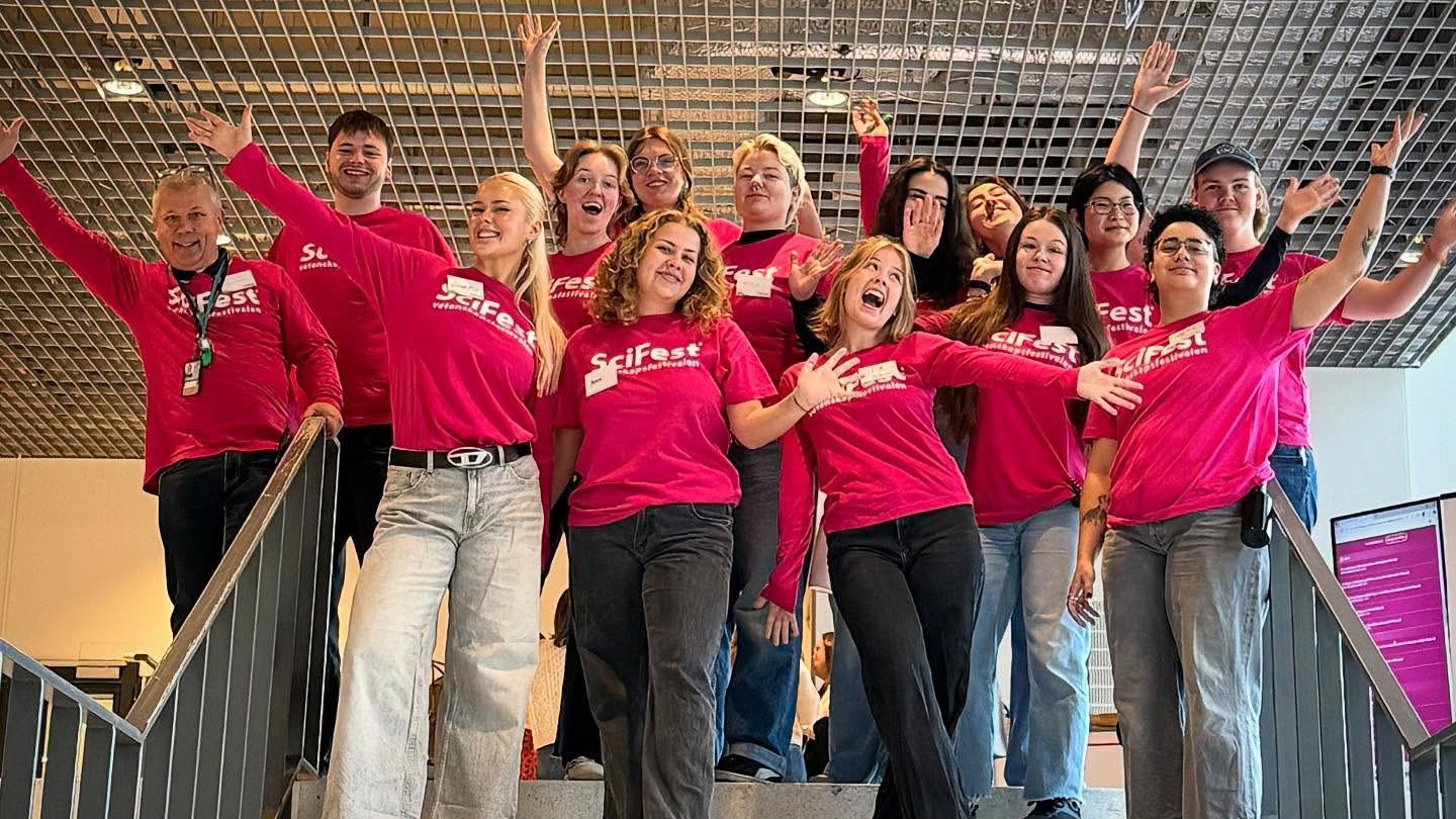 A group of happy young people on a staircase.
