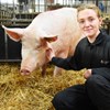 A picture of a student and a pig