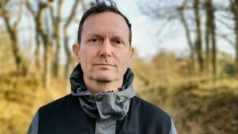 Portrait photo of a man outdoors.