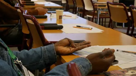 Participants holding seeds in their hands during the reflective process.