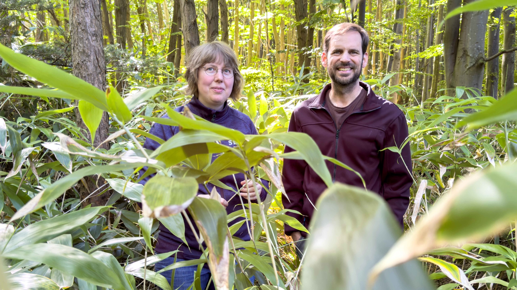 a man and a woman in the forest