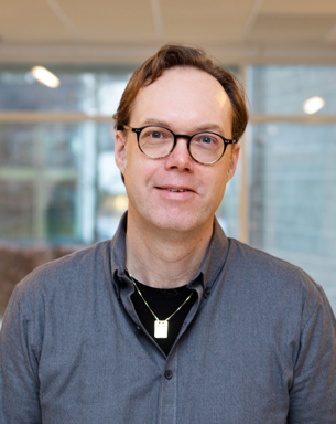 Portrait photo of a man indoors.