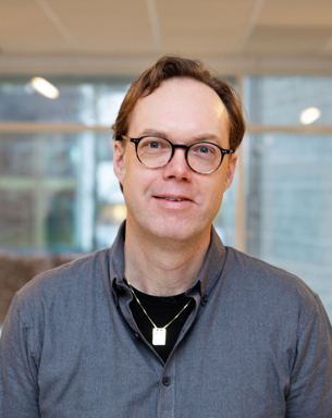 Portrait photo of a man indoors.