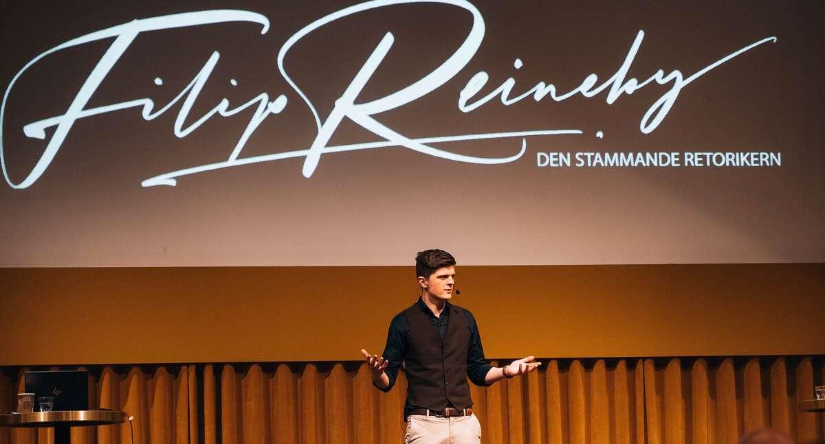 Filip Reineby speaking on stage