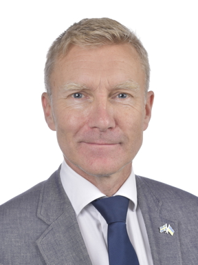 Man med ljust hår och grå kavaj. Foto