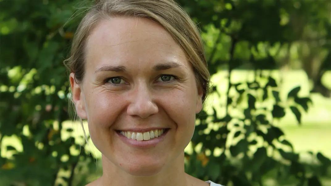 Portrait photo of a woman outdoors.