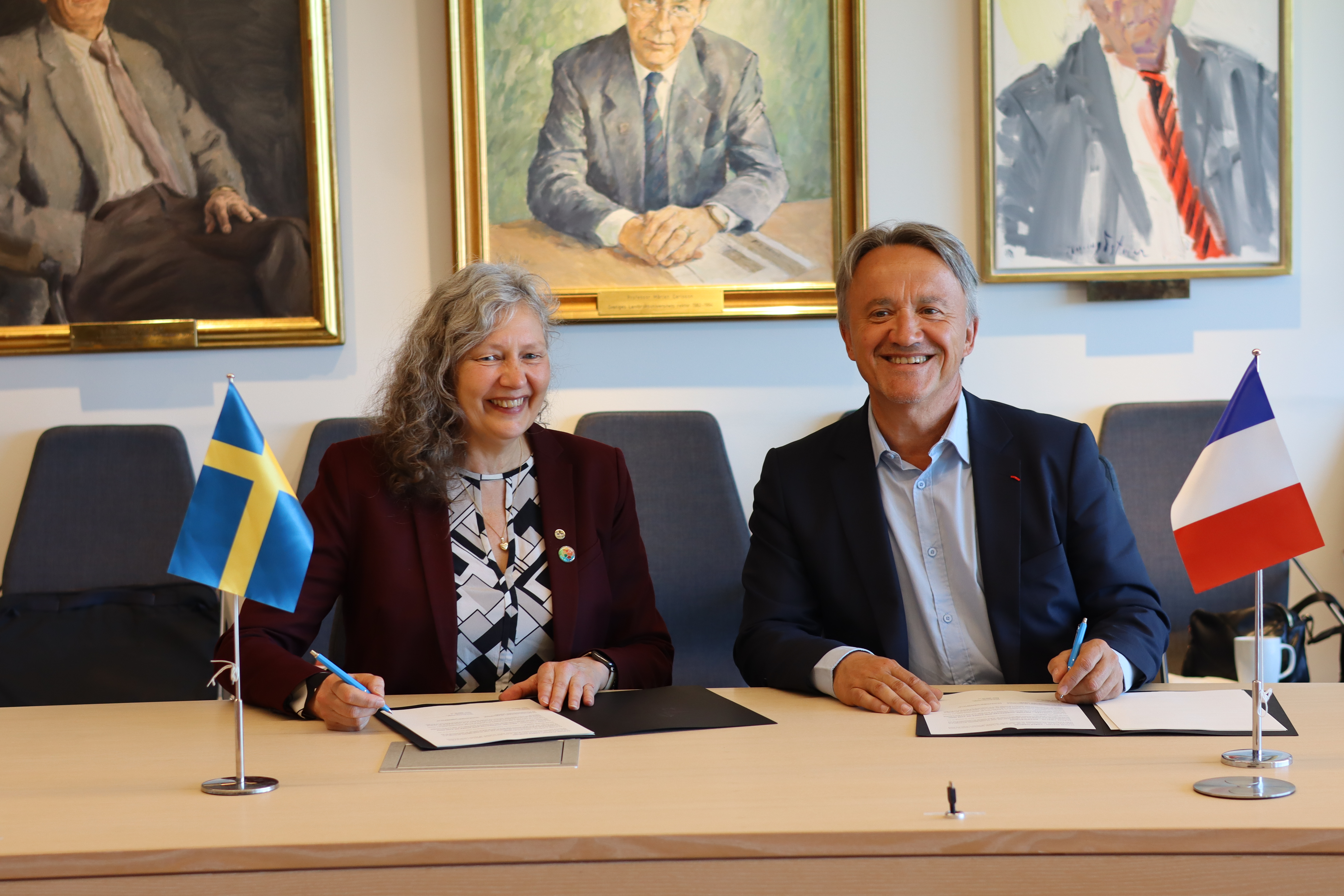 A woman and a man signing a document
