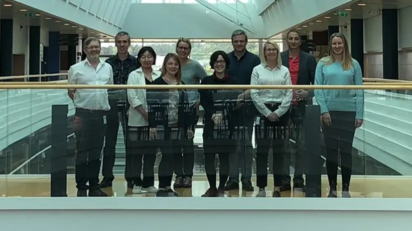 Group picture indoors in dim light.