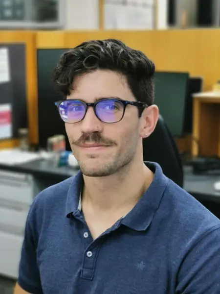 Photo of a man (Hector Marina, SLU) sitting in front of a computer.