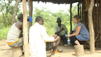 A few persons sitting outside discussing.