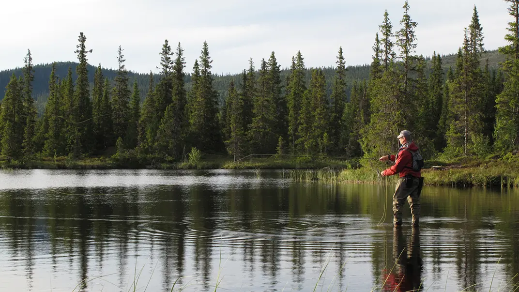 Man fishing in small lake