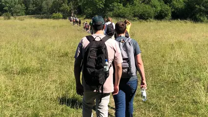 People on a path over a field