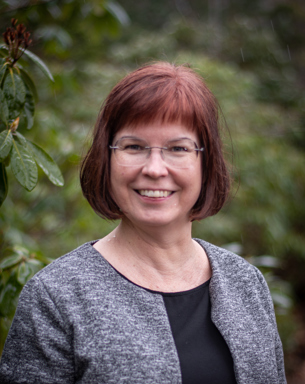 Portrait photo of a woman outdoors.