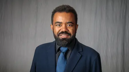 Portrait image of Costa Joao. Gray background.