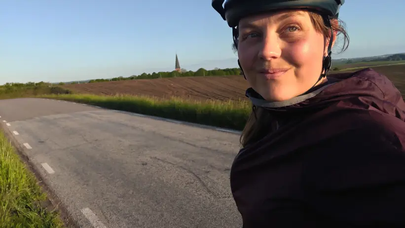 Person in outdoor clothing and a helmet taking a selfie.
