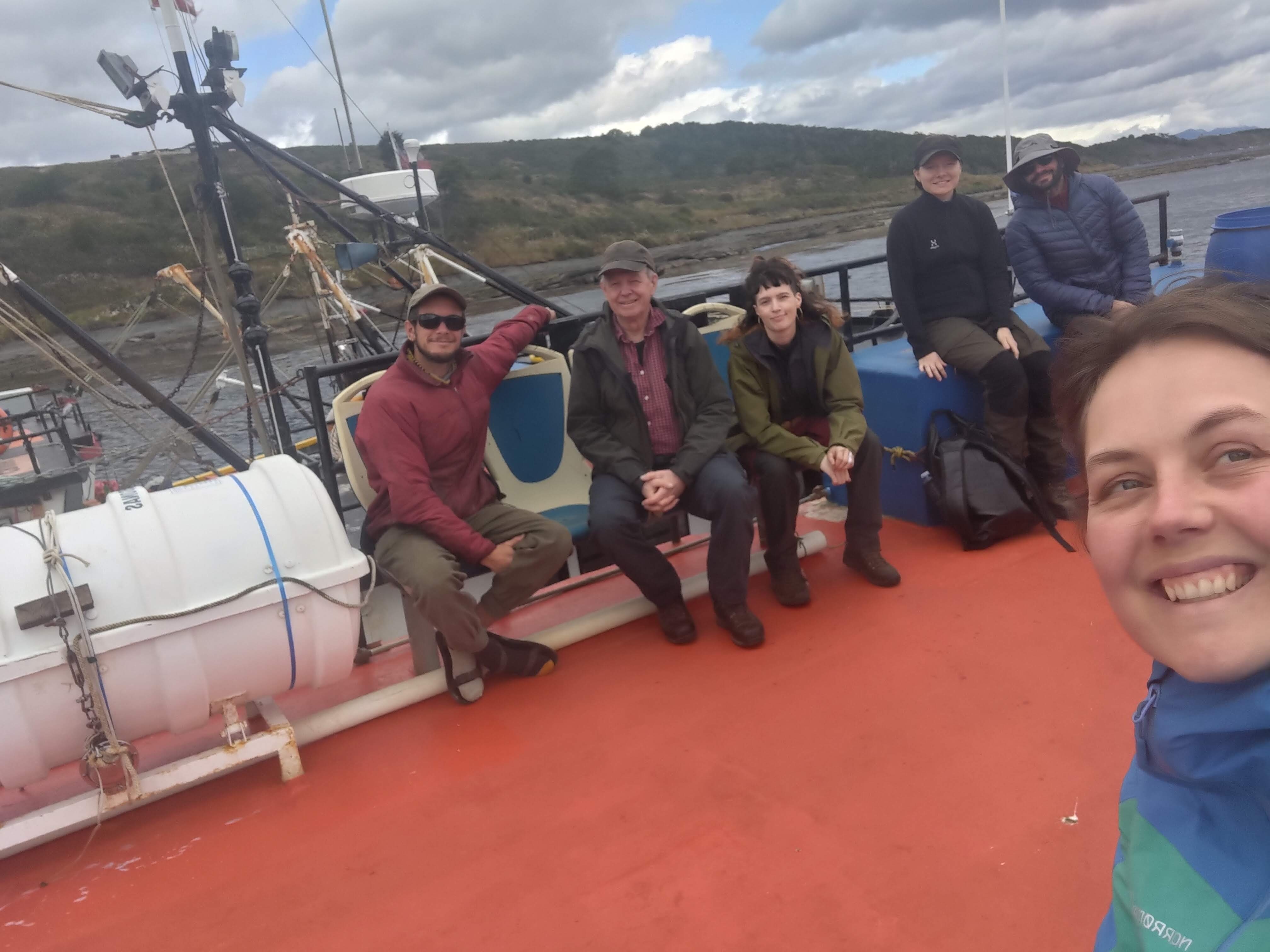 The research team sitting together on the boat deck.