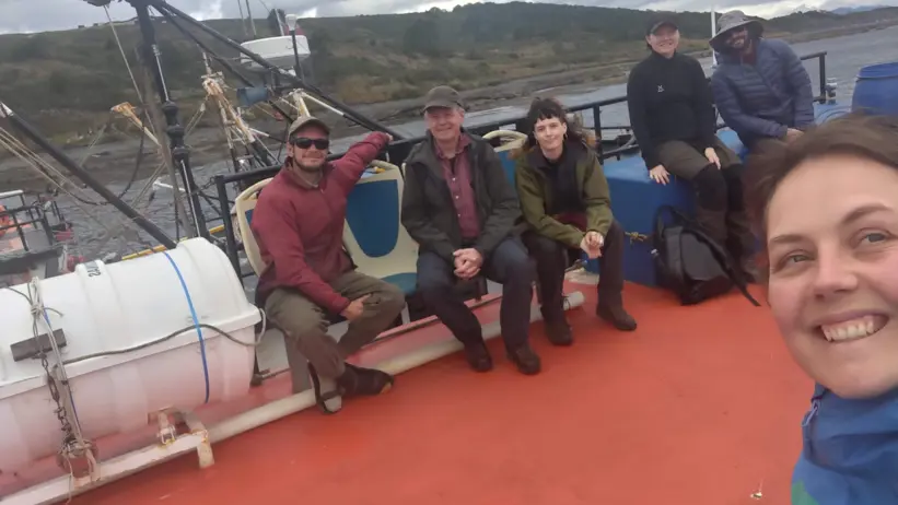 The research team sitting together on the boat deck.