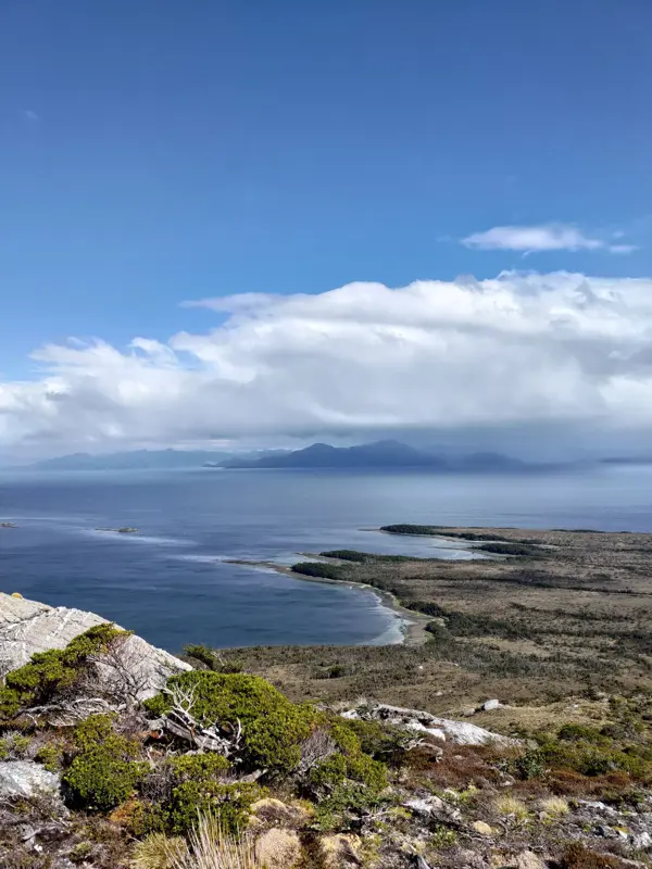 View of coastal landscape with four headlands and the sea beyond.