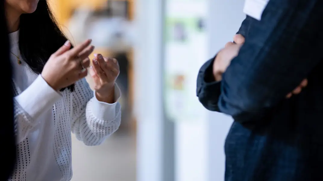 Photo of two people discussing