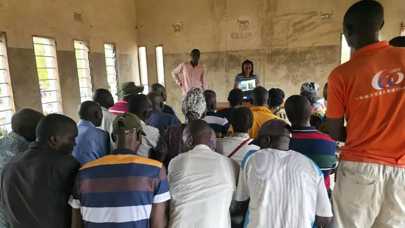 Farmers reviewing goat health pictures on the laptop during the workshop. Photo: N. Nanguna