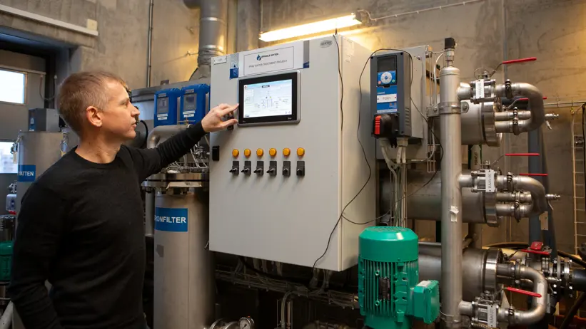 A person adjusting some sort of technical equipment, on a control panel.