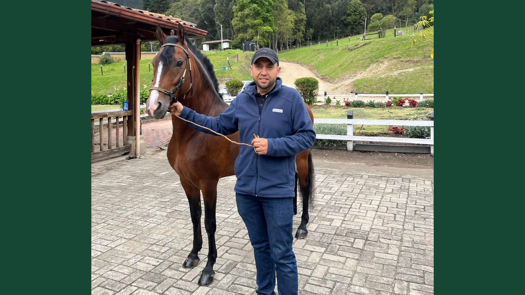 Photo of a man standing next to a Colombian Paso horse, outdoors in Colombia.