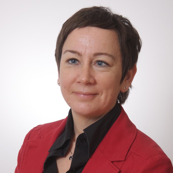 A woman wearing red. Photo.
