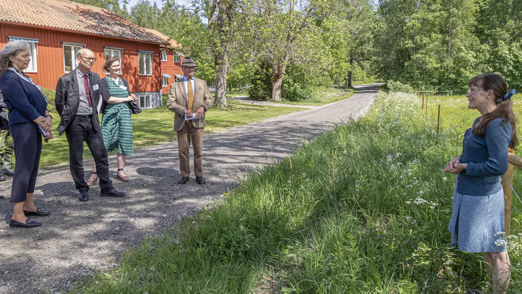 Group at fence in pasture.