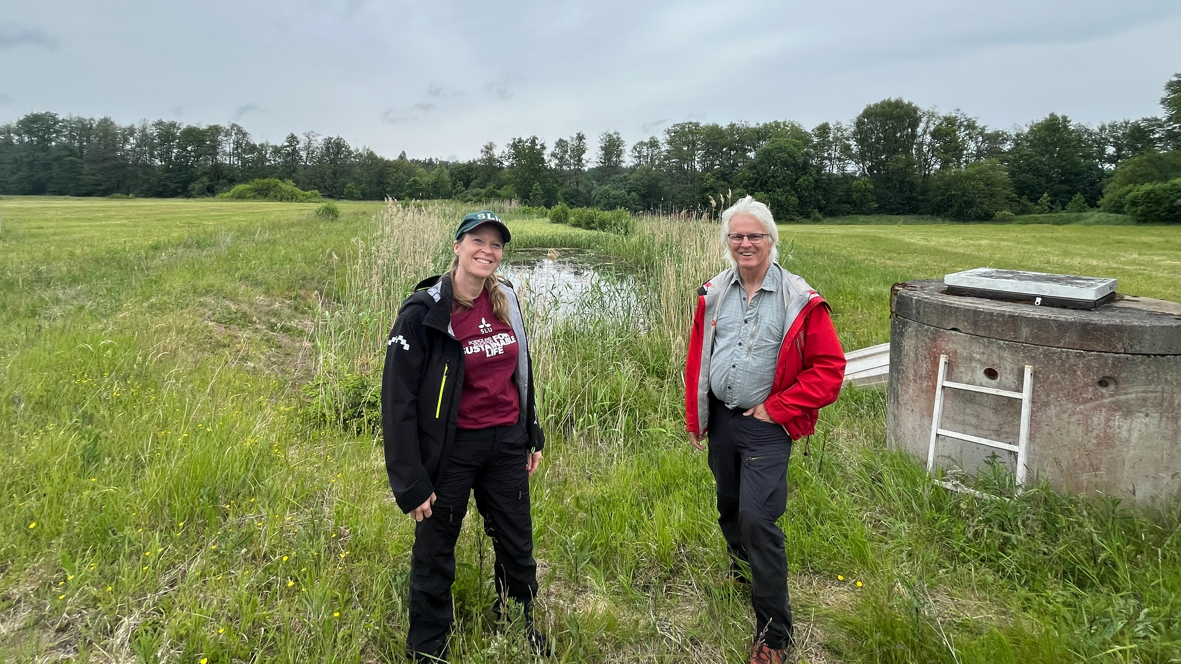 Picture of a woman and a man by a wetland. 