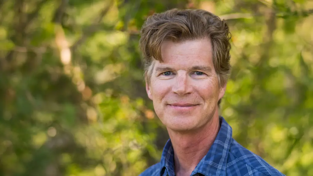 Portrait photo of a man outdoors.