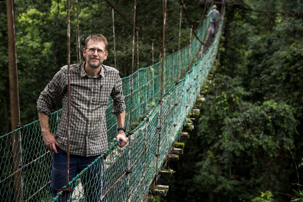 man at a suspension bridge
