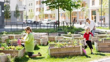 Three people growing vegetables in an urban environment. Photo by Lieselotte Van Der Meijs, CC BY-NC 2.0.