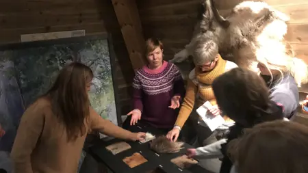 Bild inomhus på en grupp som känner på djurskinn.