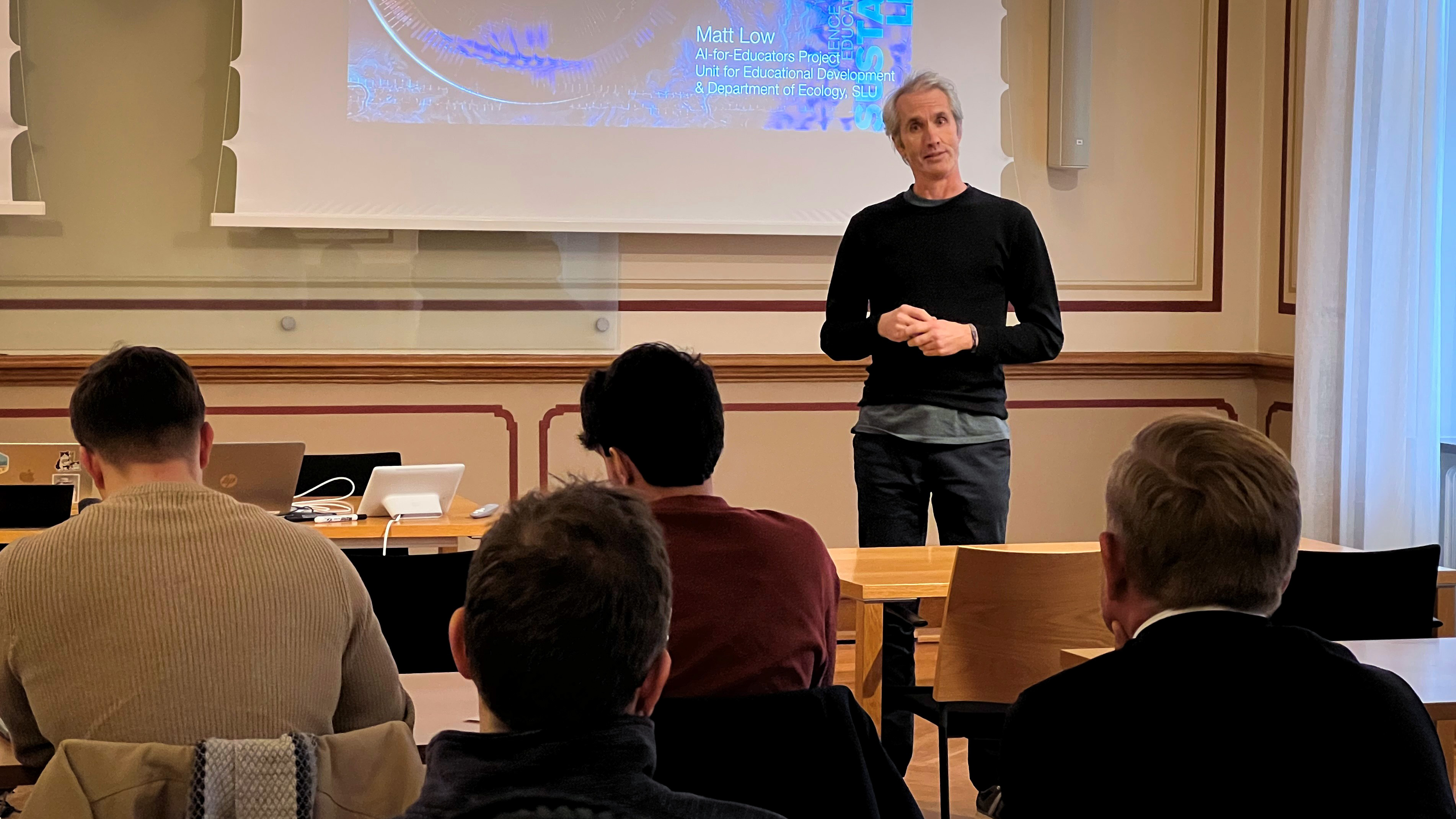 En man föreläser framför publik