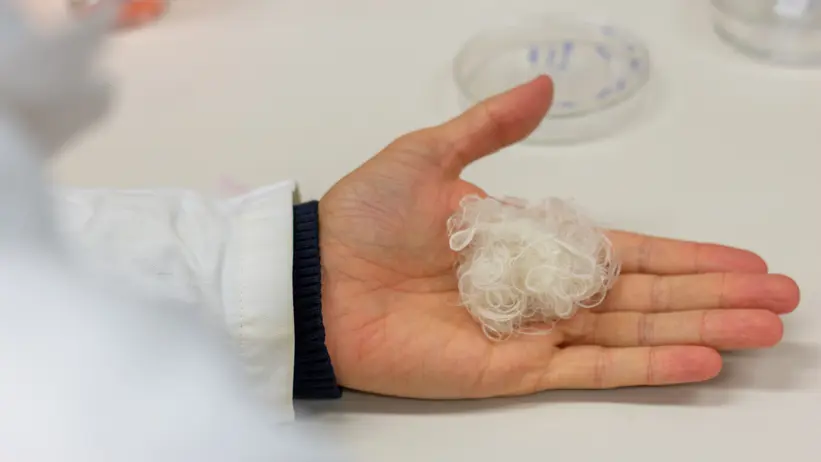 Photo of a ball of artificially spun spider silk in a laboratory.