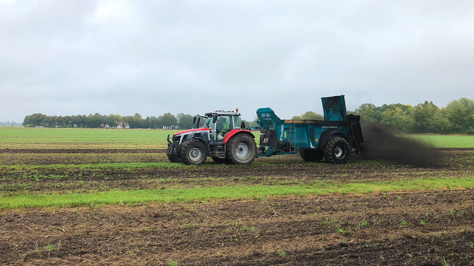 Tractor in a field spreading biochar
