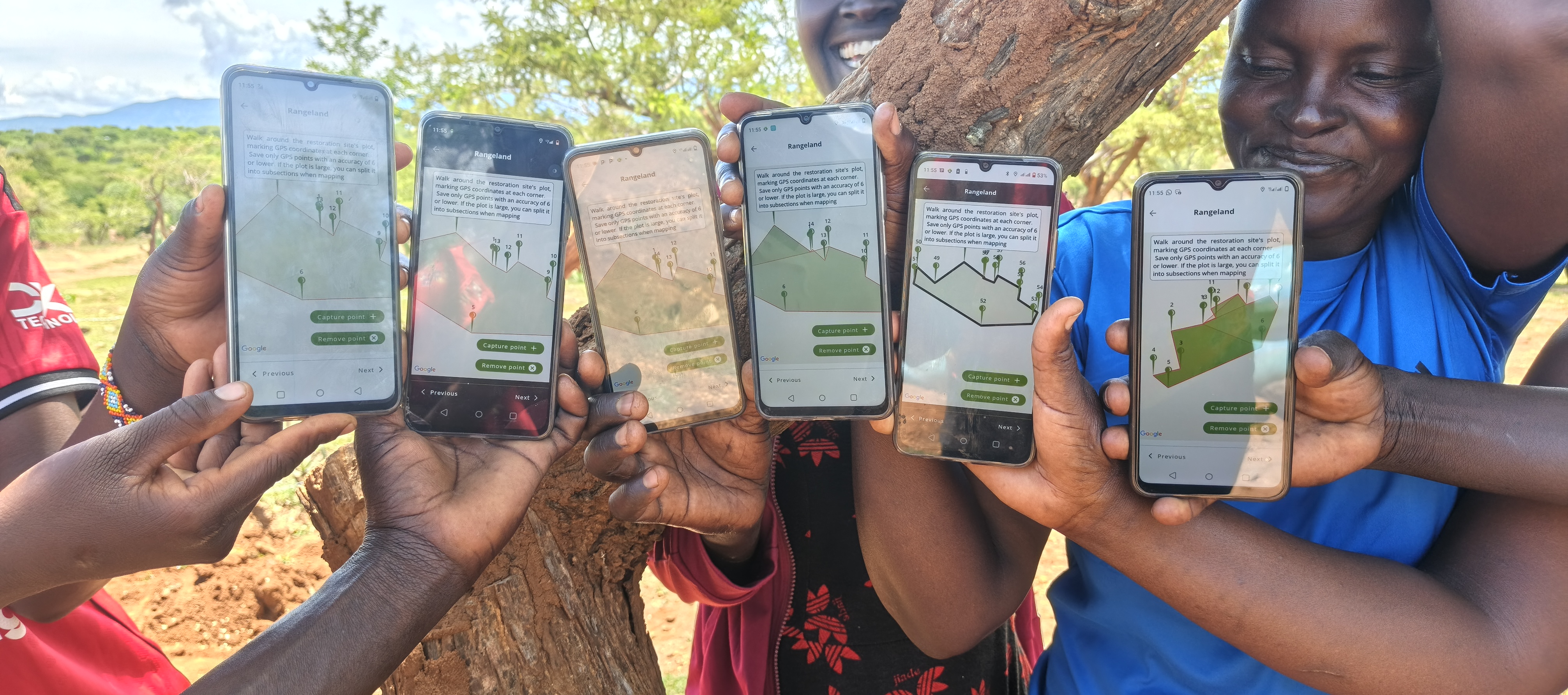Community facilitators display restoration plots tracked using the Regreening App during a practical monitoring session at the Kawoson Livestock Café site. Photo F. Ndungu