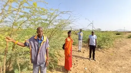 A man standing next to a camel