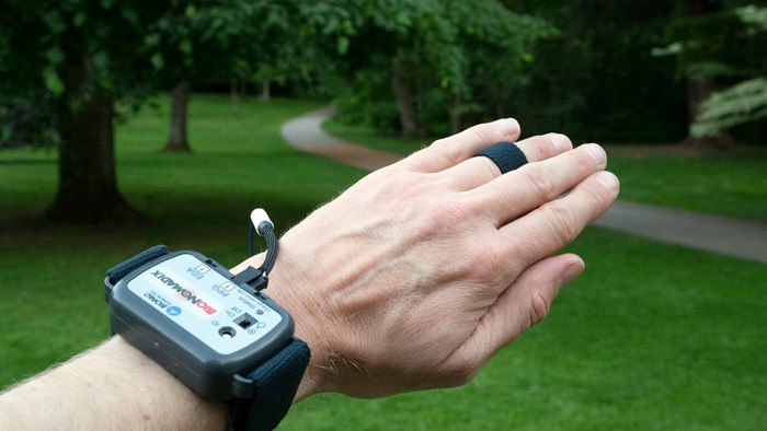 A hand with measuring instruments in a park. Photo.