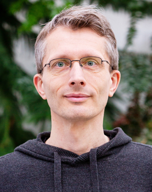 Portrait photo of a man outdoors.