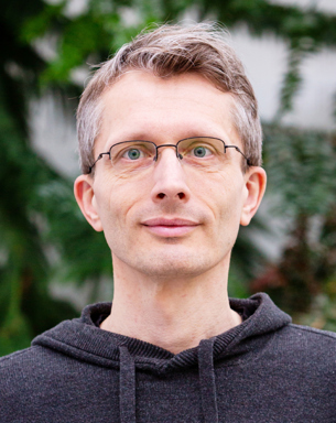 Portrait photo of a man outdoors.