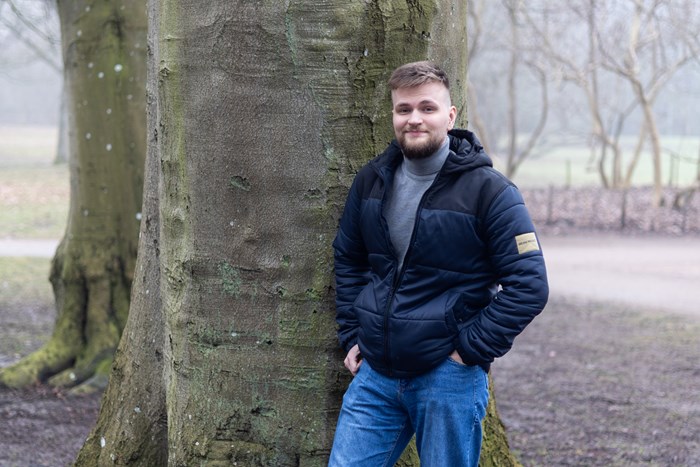Man in front of a big tree