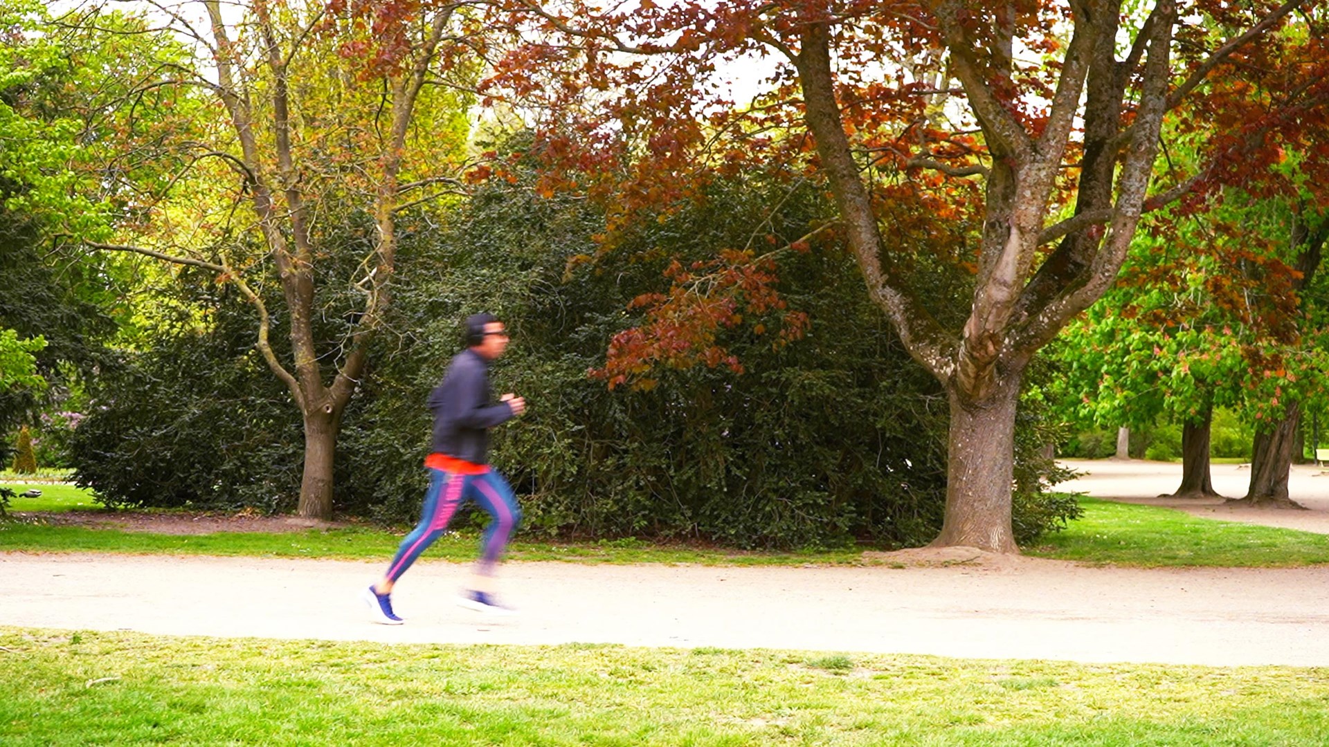 Picture of a running person in a park.
