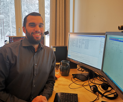 System Administrator, Mohamed Amin Kaafar are sitting at his desk, photo