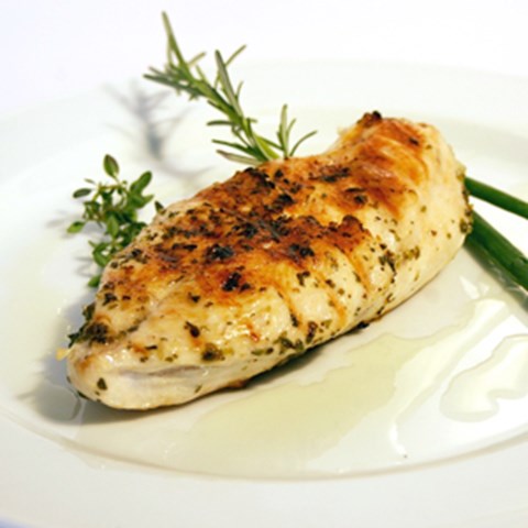 A grilled chicken fillet on a plate. Photo. 